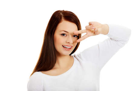 Young happy woman showing two fingersの写真素材