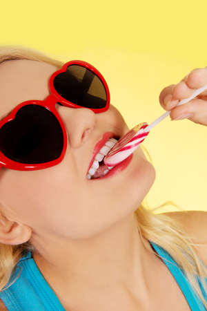 Young happy woman holding lollipopの写真素材