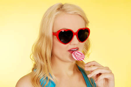 Young happy woman holding lollipopの写真素材