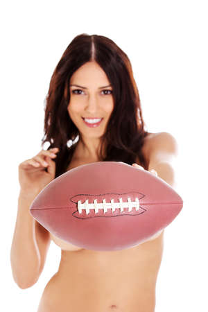 Beautiful nude woman holding american football ball.の写真素材