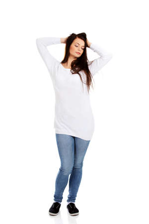 Young beautiful woman massaging her own hairsの写真素材