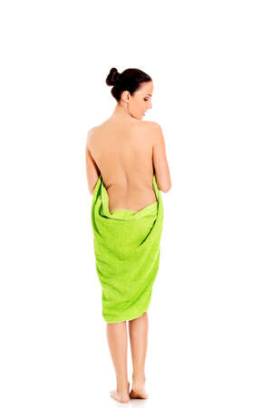 Young beautiful woman after bath full portrait isolated over white.の写真素材