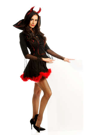Woman wearing devil clothes holding white bannerの写真素材