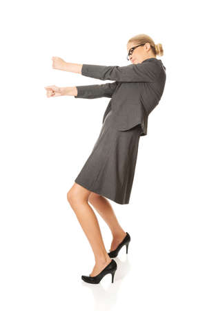 Businesswoman pulling a stickの写真素材