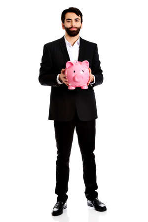 Businessman holding a piggy bank.の写真素材
