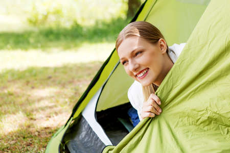 Young woman resting in a tent on the natureの写真素材