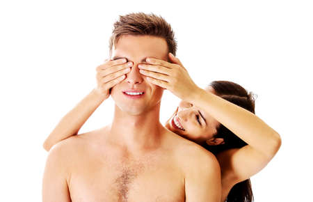 Girlfriend covering the eyes of her boyfriend for a surprise - isolatedの写真素材