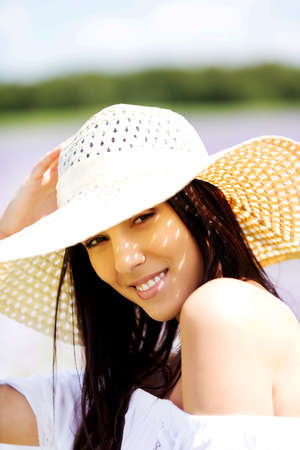 Happy woman in summer field. Young girl relax outdoors. Freedom concept.の写真素材