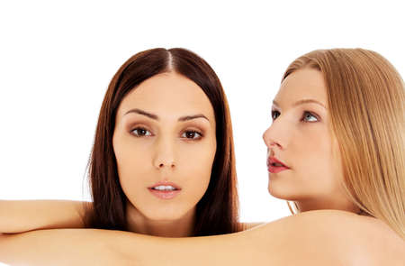 Beauty portrait of a two beautiful young women, studio whiteの写真素材