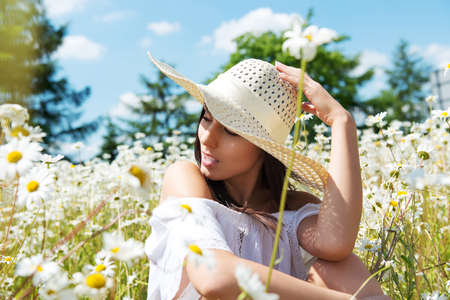 Happy woman in summer field. Young girl relax outdoors. Freedom concept.の写真素材