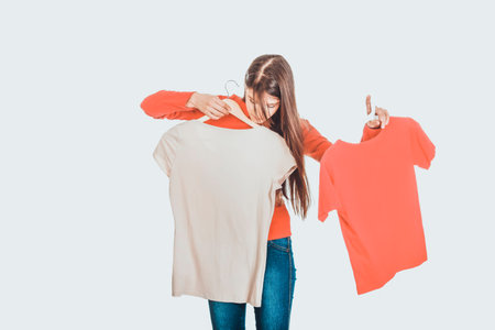 Young woman choosing shirt.の写真素材