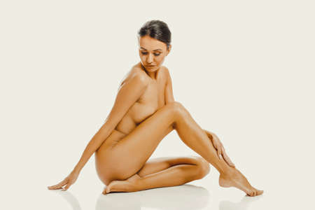 Spa woman sitting touching her footの写真素材