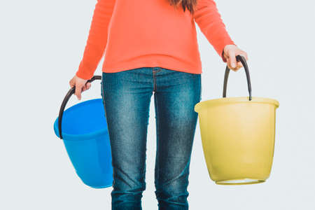 Woman holding empty plastic buckets.の写真素材
