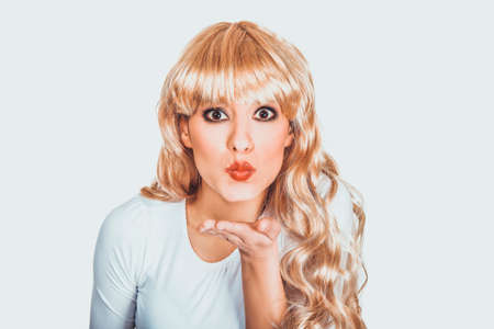 Attractive woman blowing a kiss.の写真素材