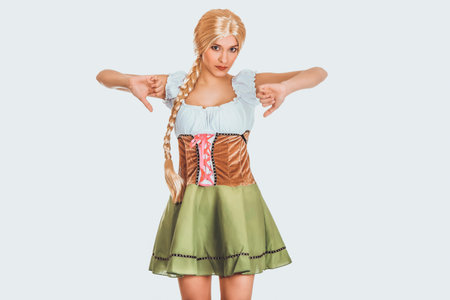 Woman in Bavarian dress with thumbs down.の写真素材