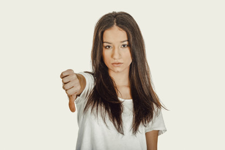 Unhappy woman with thumbs down.の写真素材