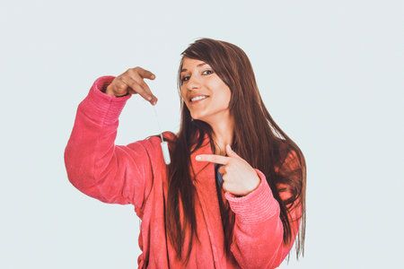 Woman in pink bathrobe with tampon.