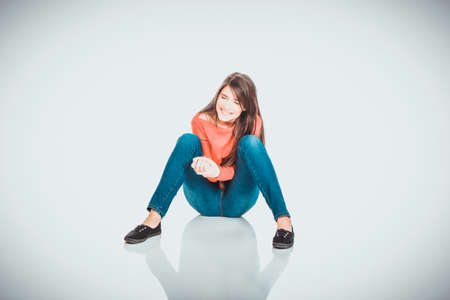 Relaxing woman sitting on the floor.の写真素材