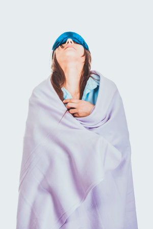 Morning woman wrapped in coverlet.