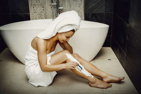 Woman shaving her leg.の写真素材