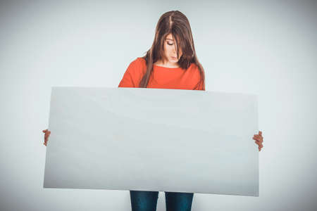 Happy woman holding empty banner.の写真素材