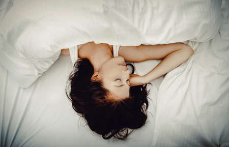 Woman sleeping in bed.の写真素材