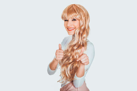 Attractive blonde woman with thumbs up.の写真素材