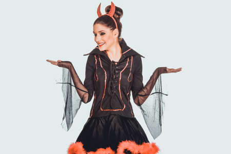 Woman in devil costume with empty hands.の写真素材