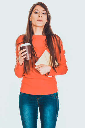 Young woman with coffee and notebook.の写真素材