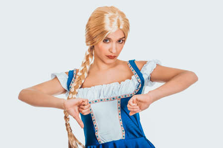 Woman in Bavarian dress with thumbs down.の写真素材