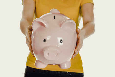 Woman holding piggybank.