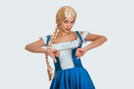 Woman in Bavarian dress with thumbs down.の写真素材