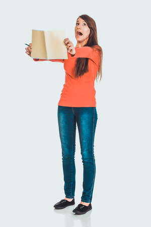 Shocked student woman with her note.の写真素材