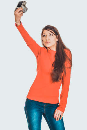 Woman taking selfie with a camera.の写真素材
