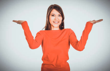 Woman making a scale with her arms.の写真素材