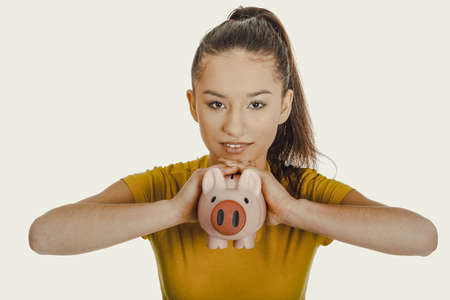 Happy woman holding piggybank.の写真素材