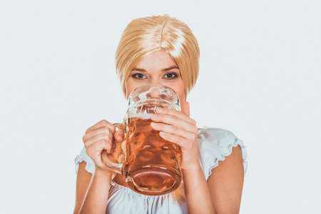 Beautiful bavarian woman drinking beer.の写真素材