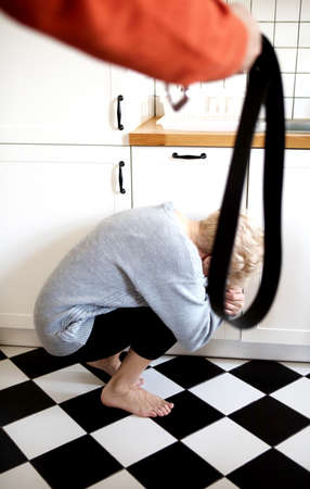 Woman covering her face in fear of domestic violenceの写真素材