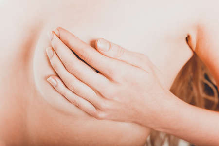 Topless woman touching her breastの写真素材