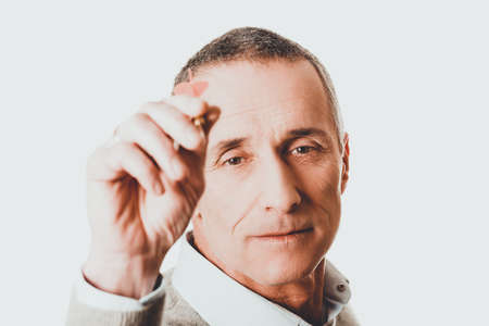Mature man playing dartsの写真素材