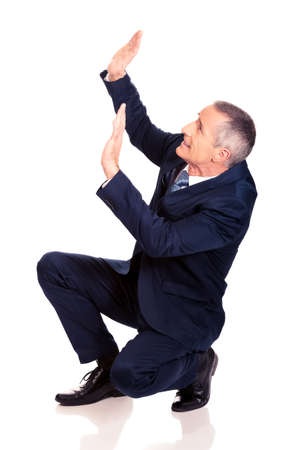 Businessman protecting himself from empty spaceの写真素材