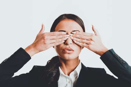Portrait of businesswoman covering eyes with handsの写真素材