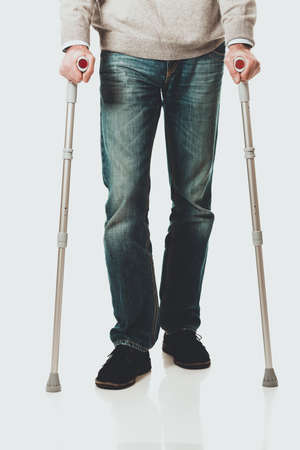 Male legs with crutchesの写真素材
