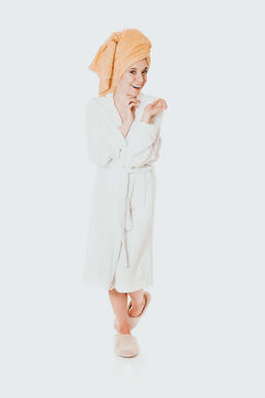 Young smiling woman in bathrobeの写真素材