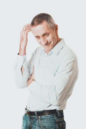 Confused man scratching his headの写真素材