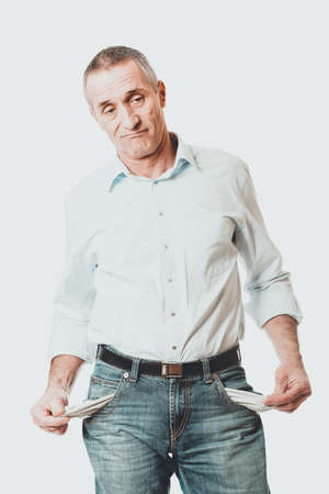 Confused man showing his empty pocketsの写真素材
