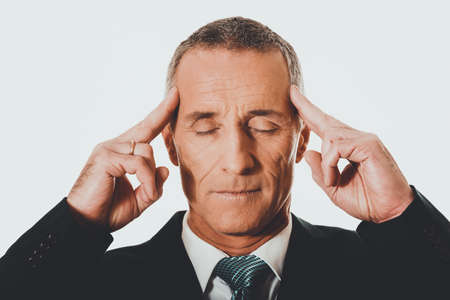 Pensive businessman touching headの写真素材