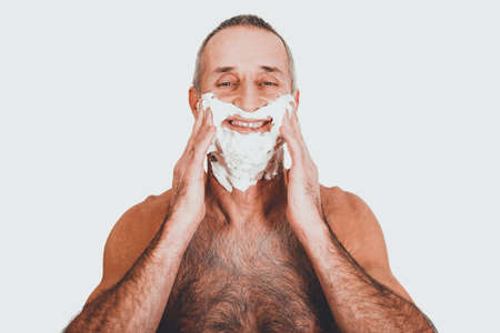 Portrait of a man applying shaving foamの写真素材