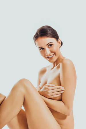 Nude woman covering her breastの写真素材