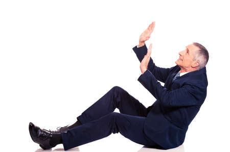 Businessman protecting himself from empty spaceの写真素材